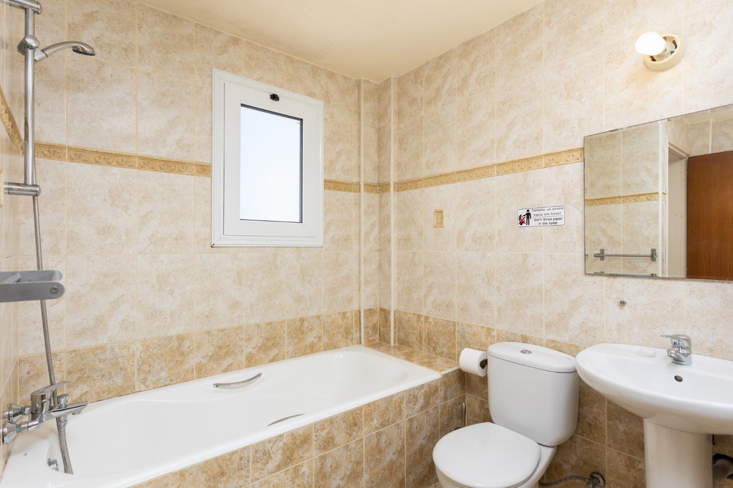 En suite bathroom with bath and shower