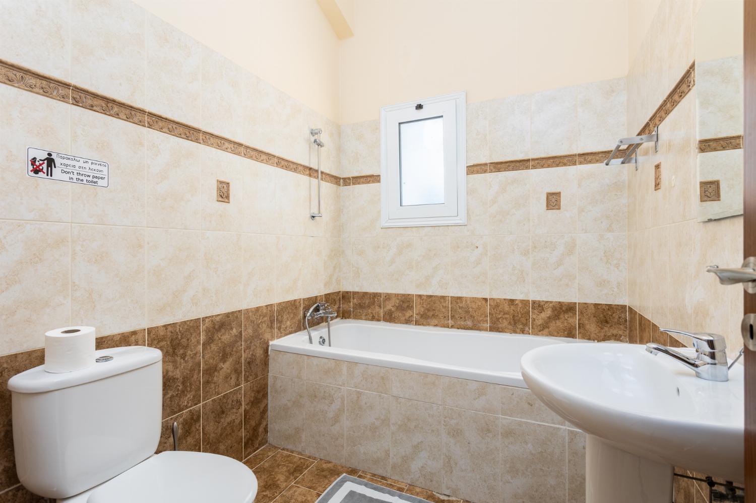 En suite bathroom with bath and shower