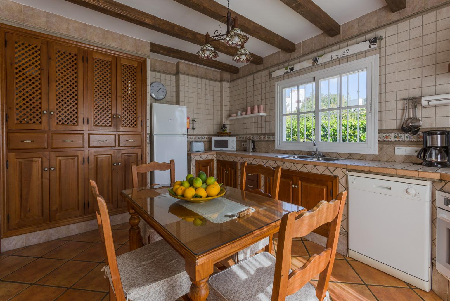 Open-plan living room with sofas, WiFi Internet, Satellite TV, DVD player, dining area and ornamental fire place. 