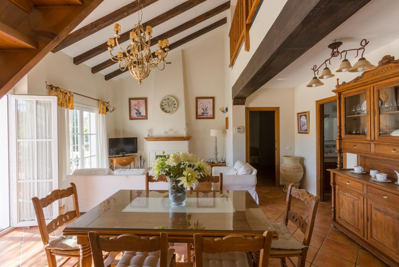 Open-plan living room with sofas, WiFi Internet, Satellite TV, DVD player, dining area and ornamental fire place. 