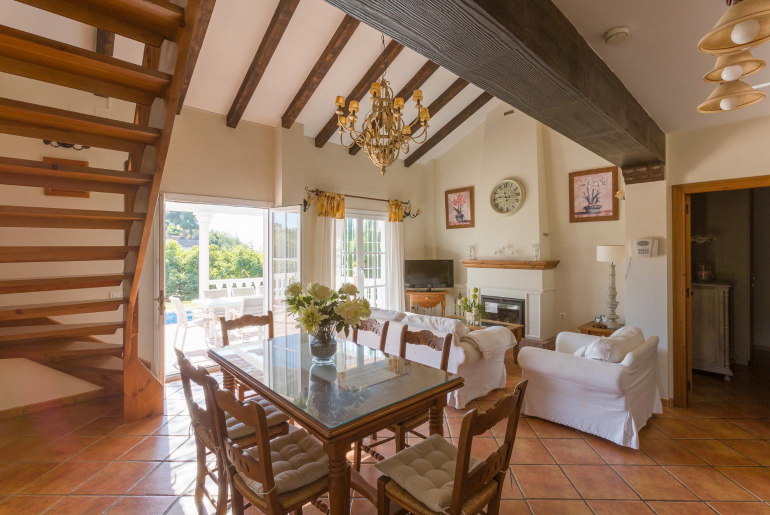 Open-plan living room with sofas, WiFi Internet, Satellite TV, DVD player, dining area and ornamental fire place. 