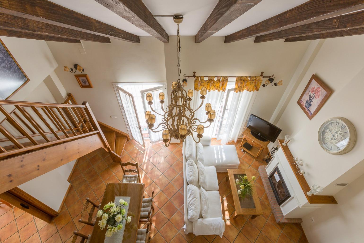 Open-plan living room with sofas, WiFi Internet, Satellite TV, DVD player, dining area and ornamental fire place. 