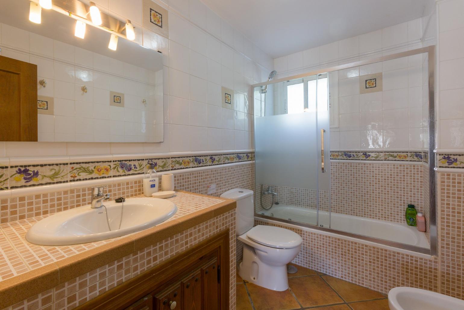 Family bathroom, bath with shower. W/C.