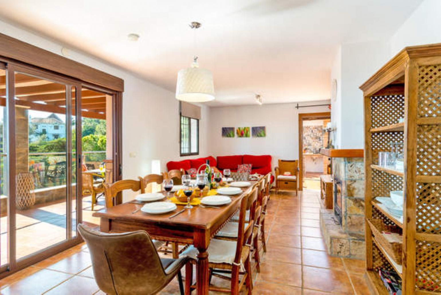 Open-plan living room with sofas, WiFi Internet, Satellite TV, dining area and ornamental fire place.