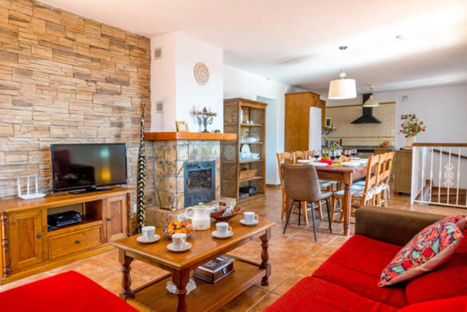 Open-plan living room with sofas, WiFi Internet, Satellite TV, dining area and ornamental fire place.
