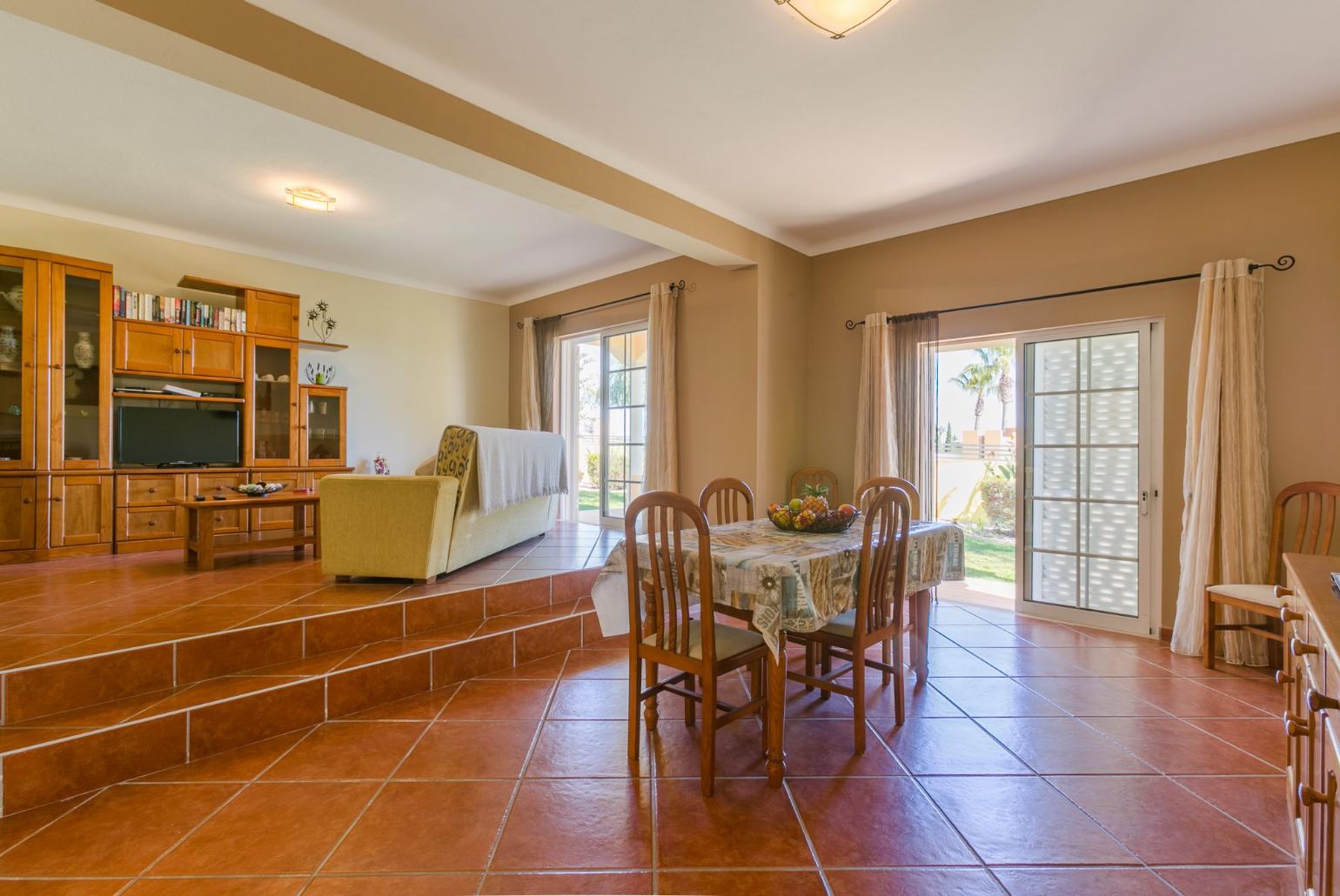 Living room with sofas, dining area, ornamental fireplace, WiFi internet, satellite TV, and DVD player