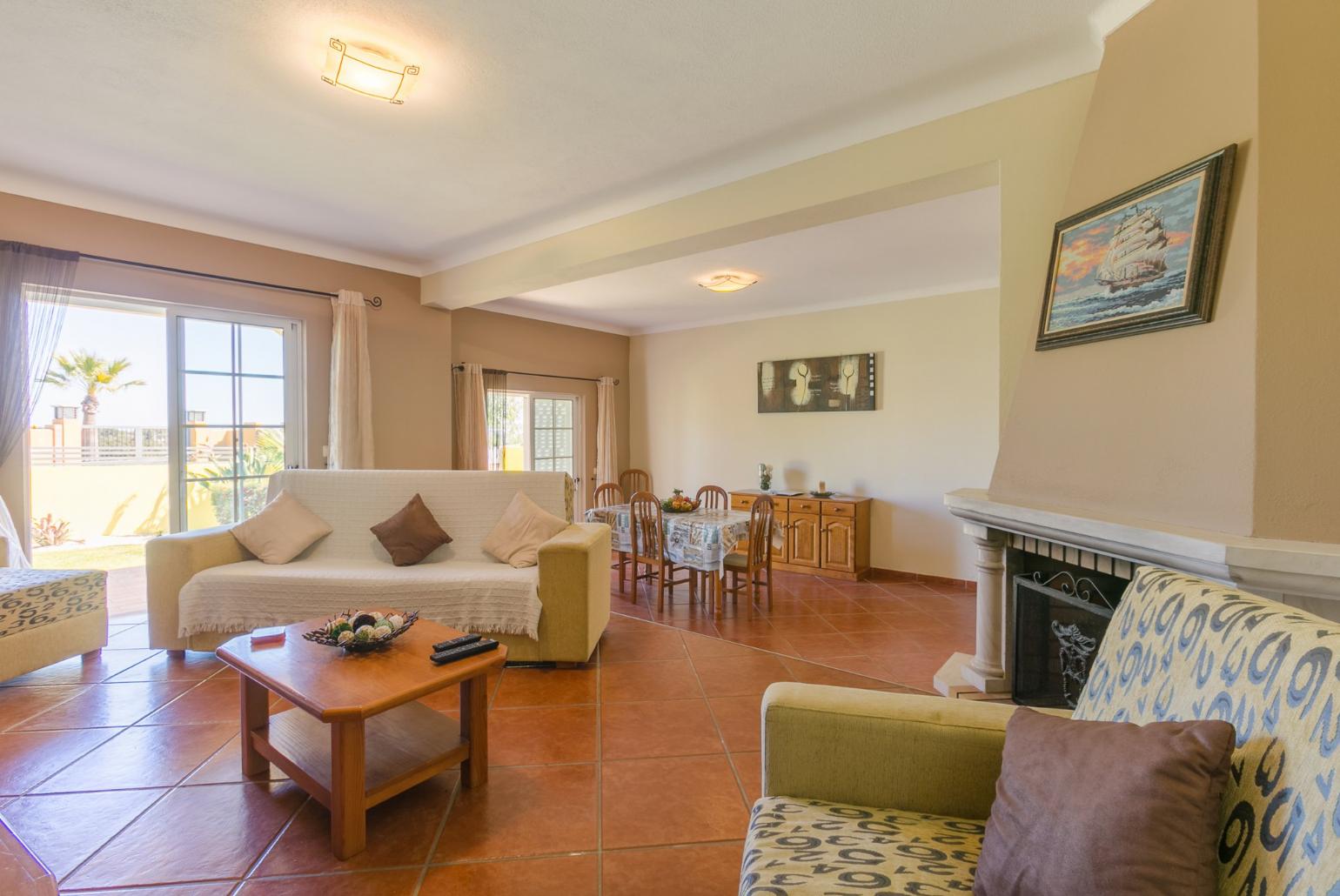 ,Living room with sofas, dining area, ornamental fireplace, WiFi internet, satellite TV, and DVD player