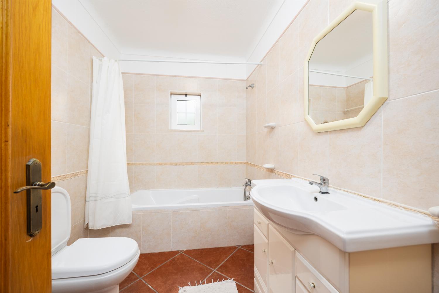 En suite bathroom with bath and shower