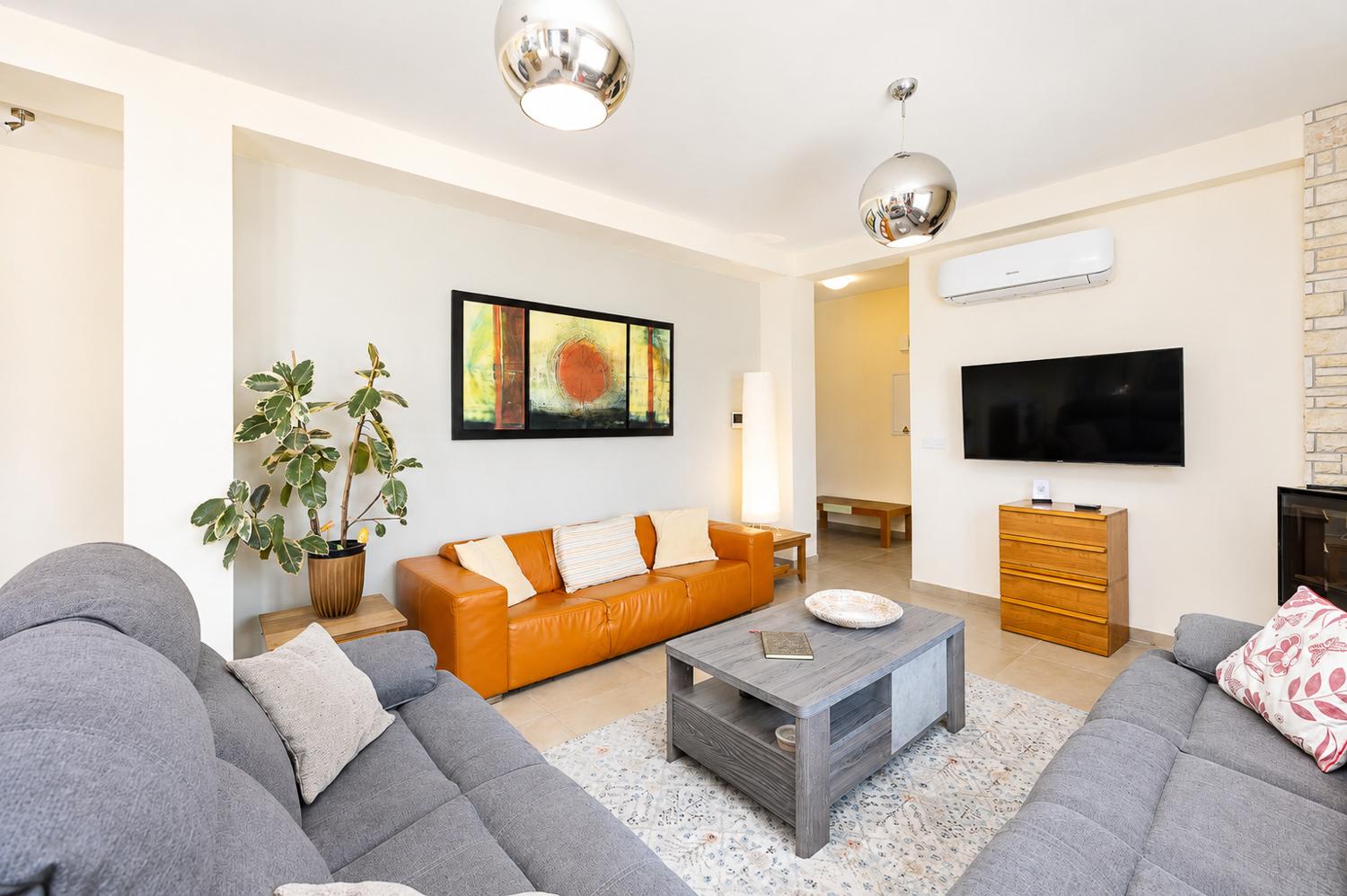 Bright living room with comfortable sofas, modern decor, and a stylish relaxing atmosphere.