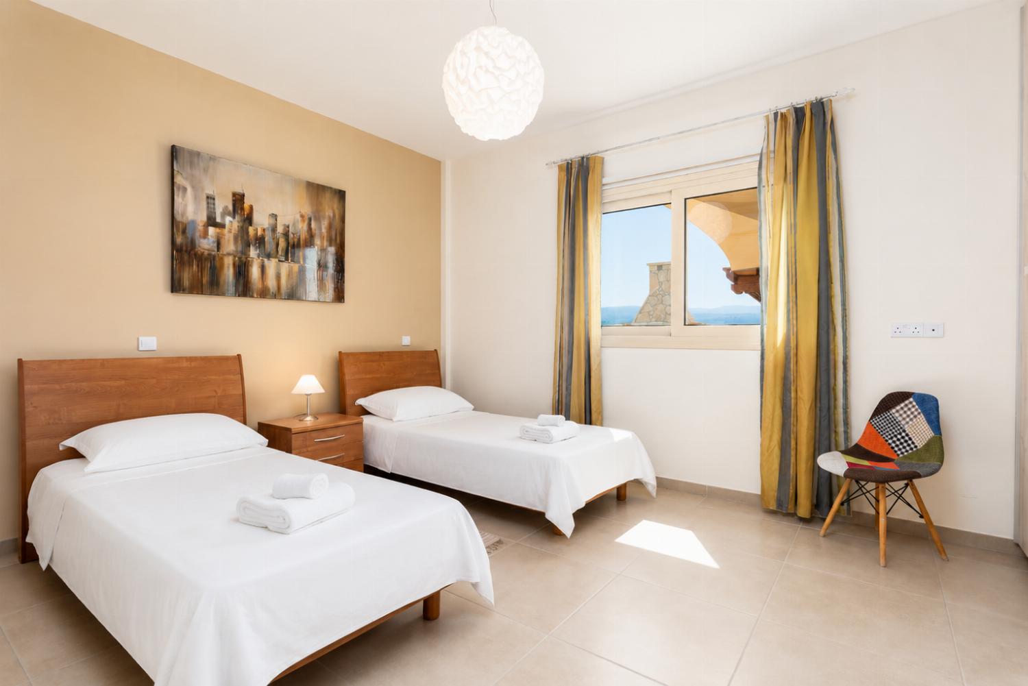 Twin bedroom on ground floor with en suite bathroom and A/C