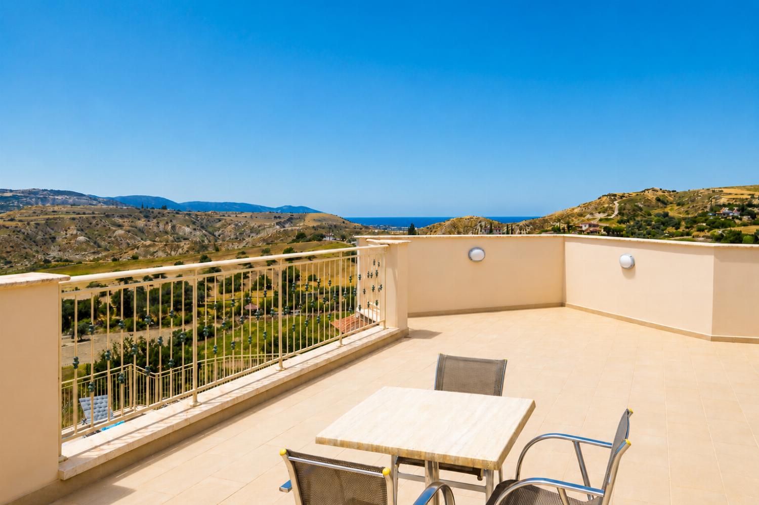 Spacious private terrace with panoramic countryside and distant sea views.