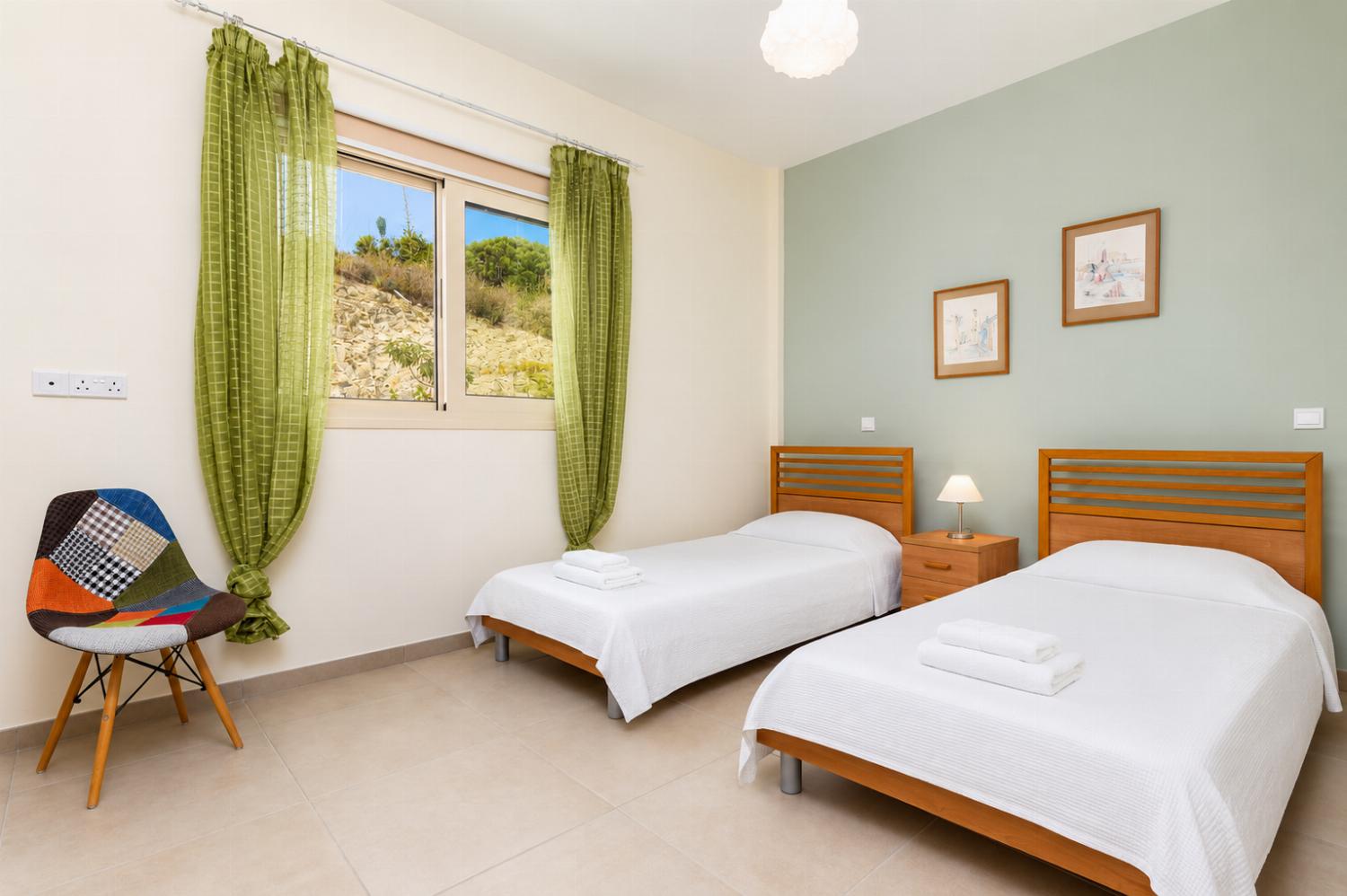 Twin bedroom on ground floor with en suite bathroom and A/C
