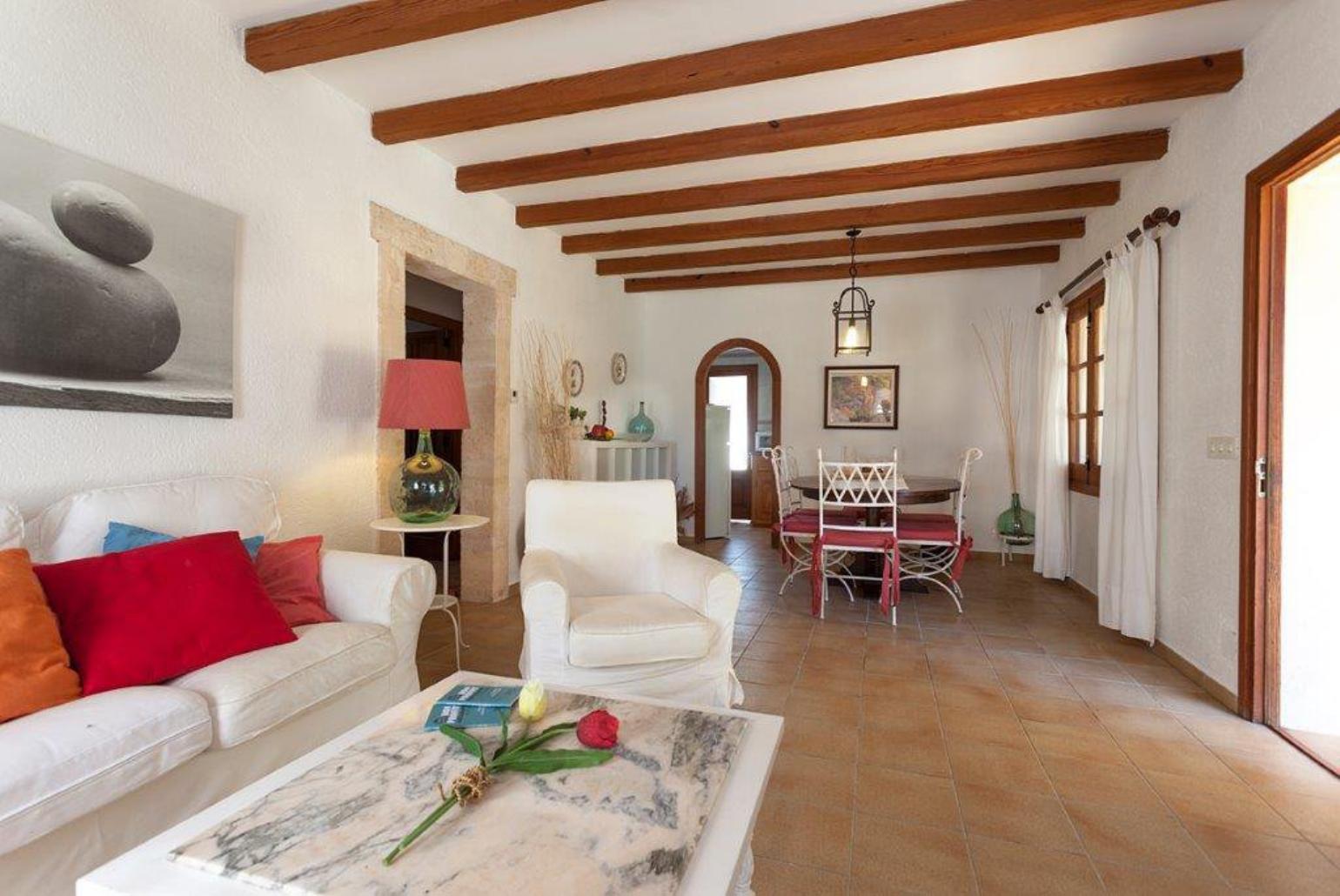Open-plan living room with sofas, dining area, A/C, WiFi internet, satellite TV, DVD player, and terrace access