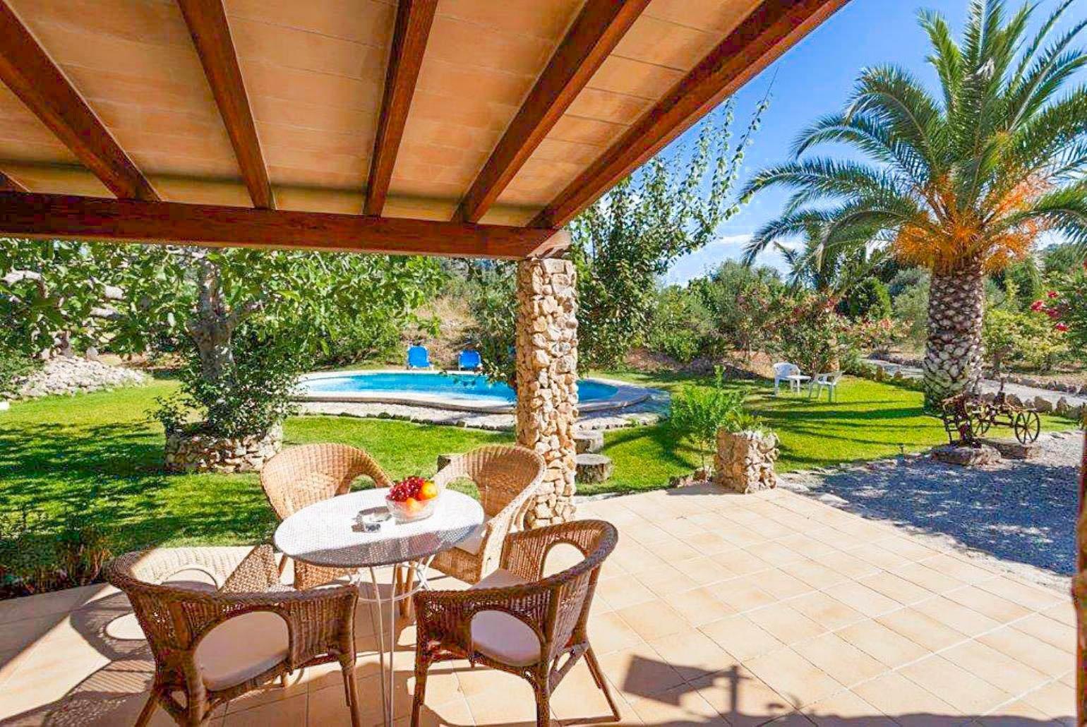 Open-plan living room with sofas, dining area, A/C, WiFi internet, satellite TV, DVD player, and terrace access
