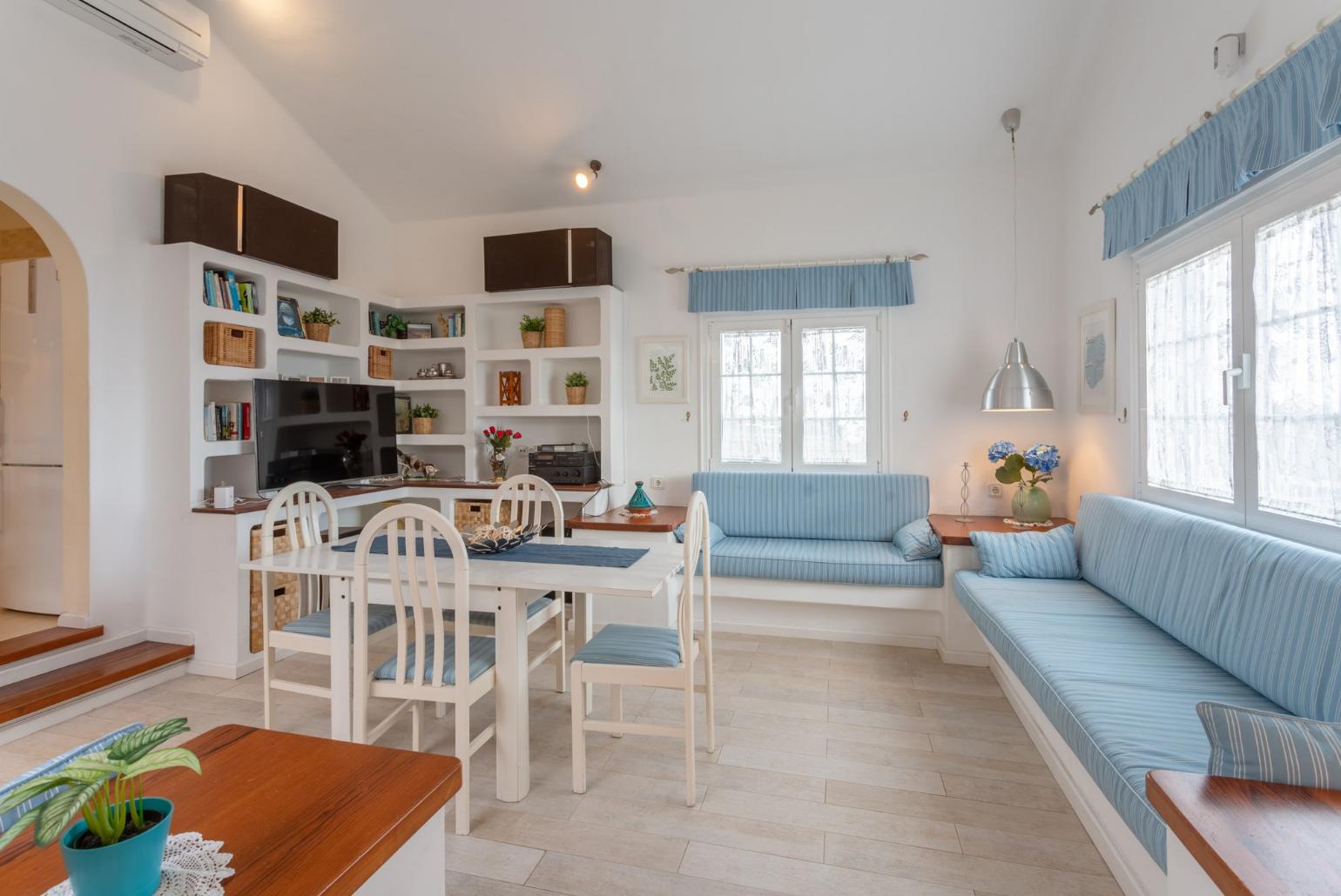 Living room with sofas, dining area, A/C, WiFi internet, and satellite TV 
