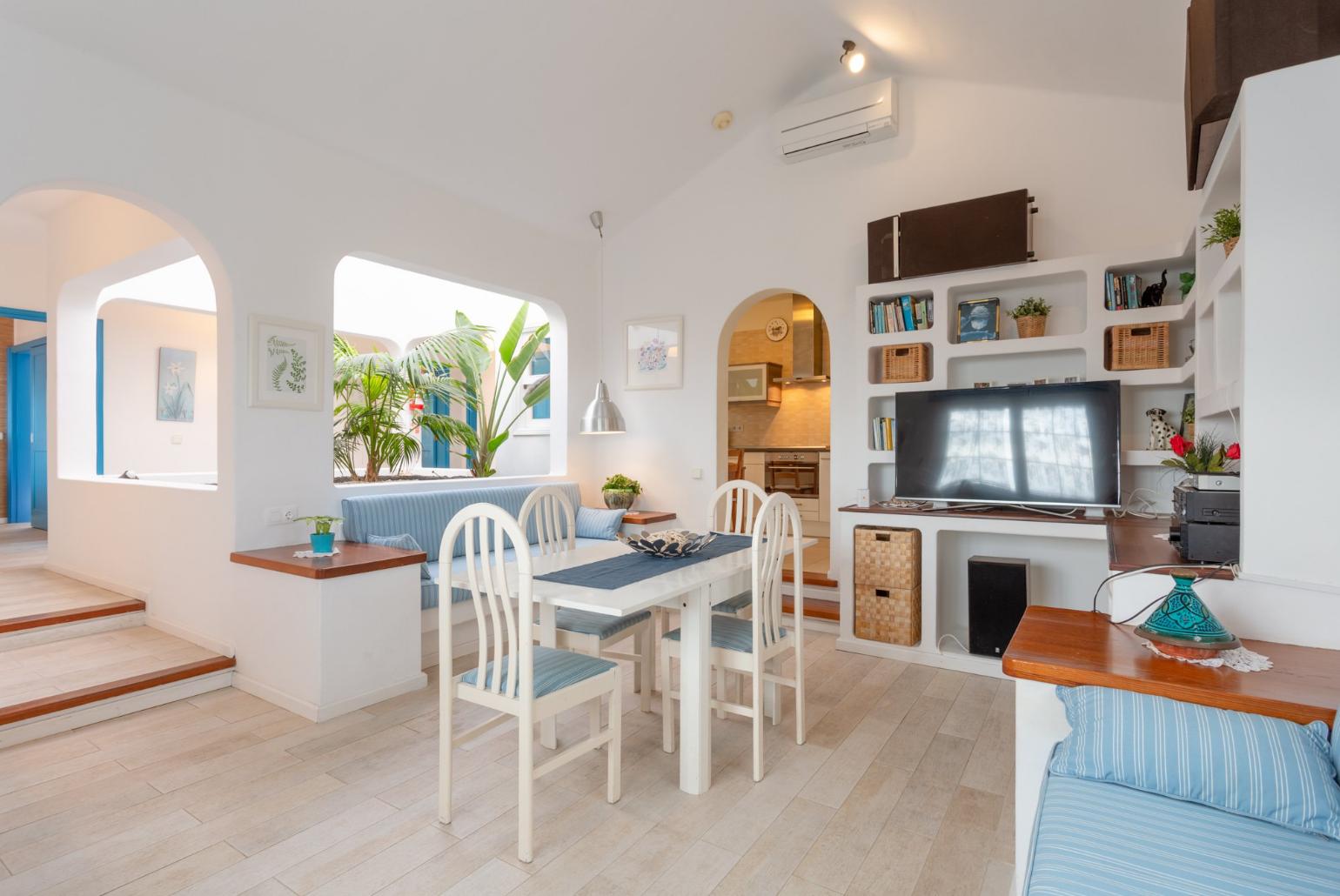 Living room with sofas, dining area, A/C, WiFi internet, and satellite TV 