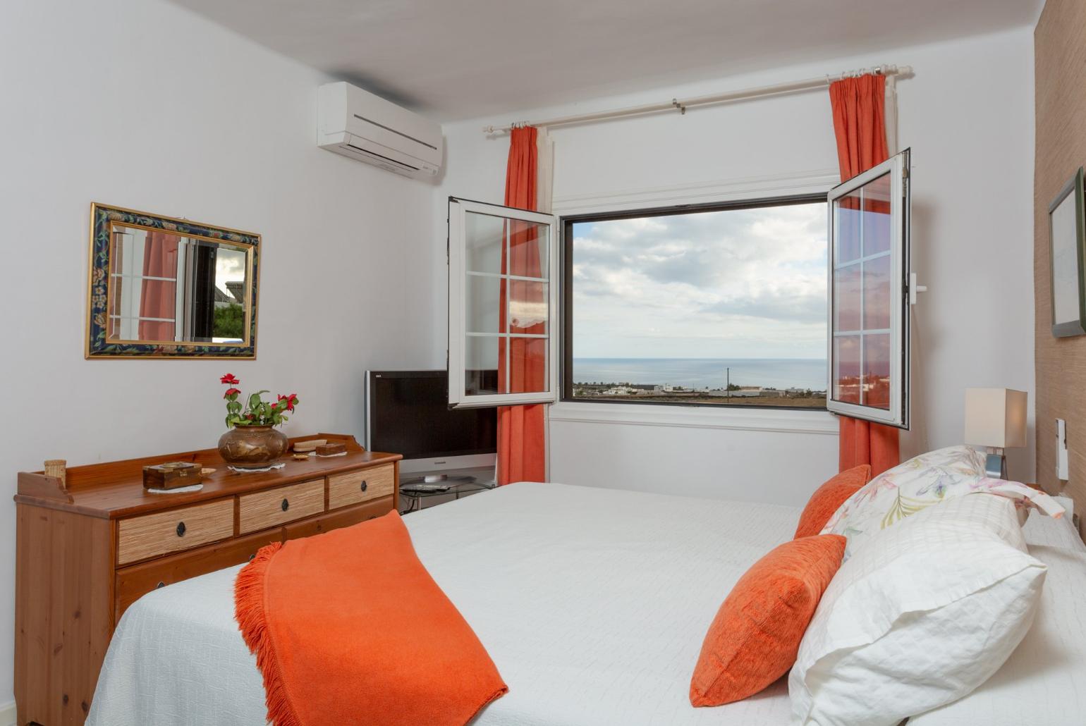 Double bedroom with en suite bathroom, A/C, and sea views