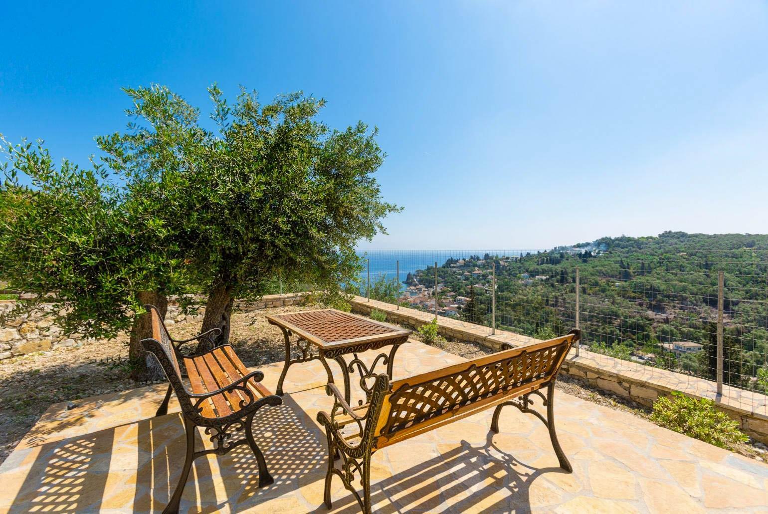 Terrace area with outdoor seating, and views of sea and Loggos