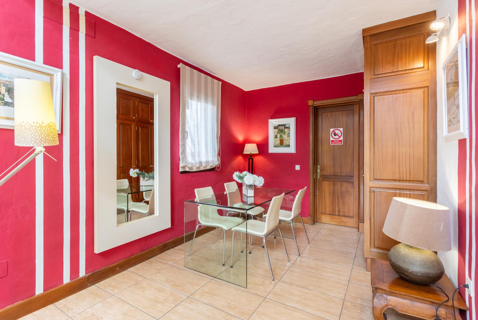 Second living area with sofa, dining area, mezzanine, and TV