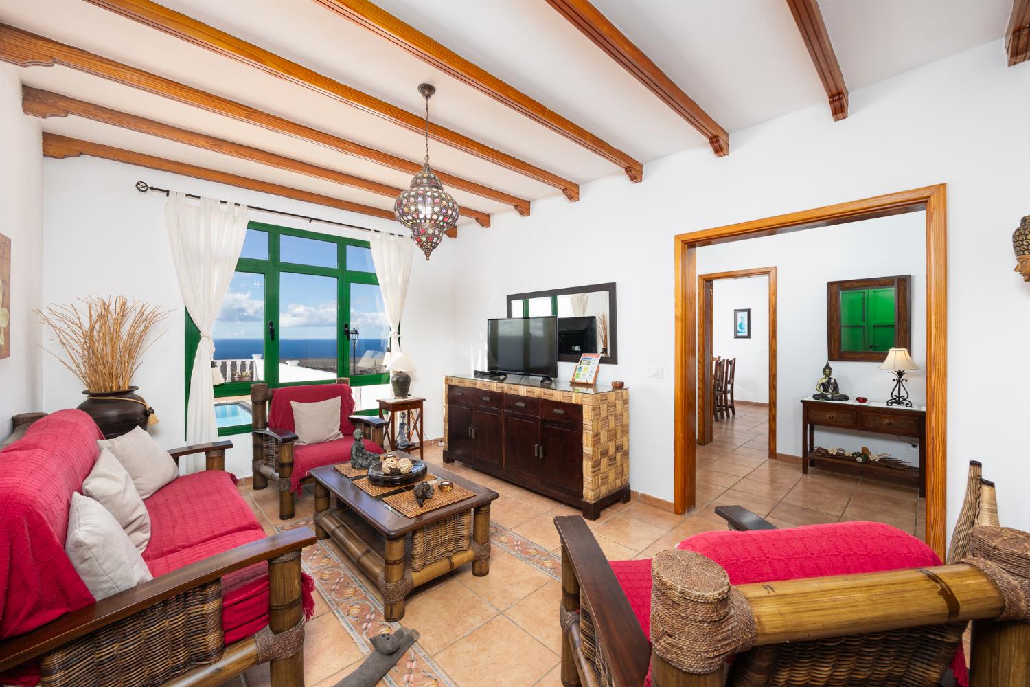Living room with sofa, dining area, WiFi internet, satellite TV, and sea views