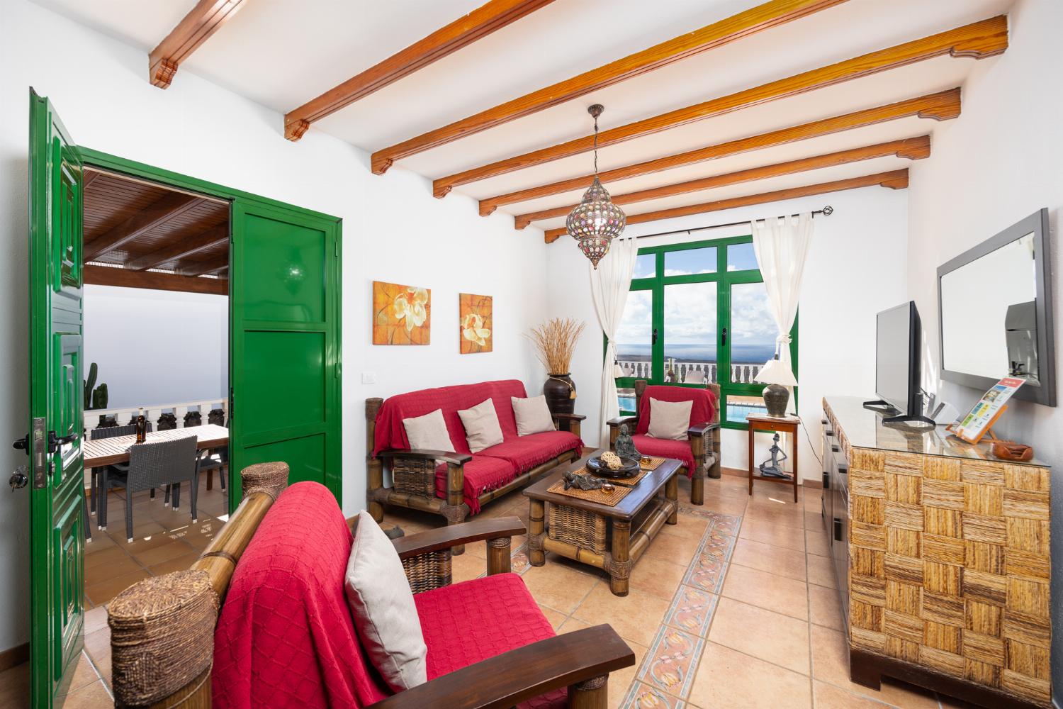 Living room with sofa, dining area, WiFi internet, satellite TV, and sea views