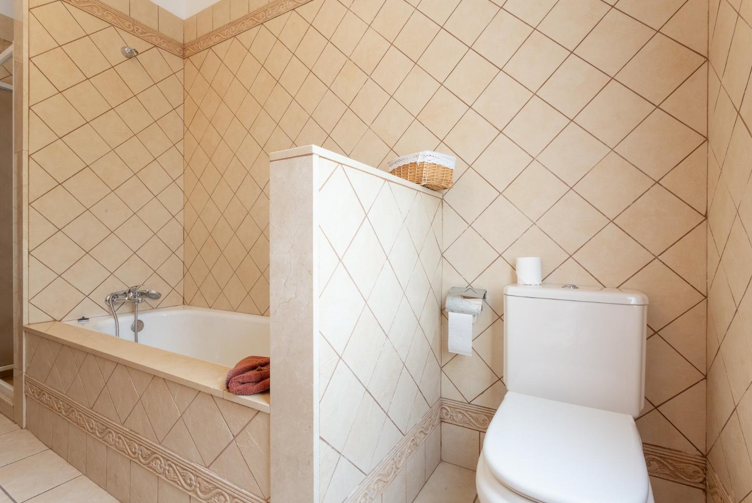 Family bathroom with bath and two overhead showers