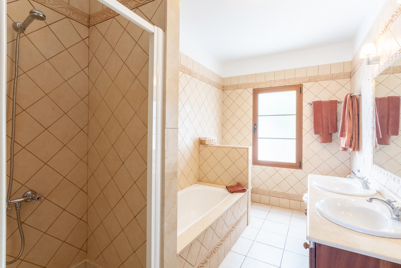 Family bathroom with bath and two overhead showers