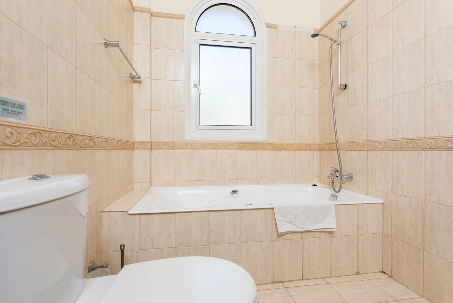 En suite bathroom with bath and shower