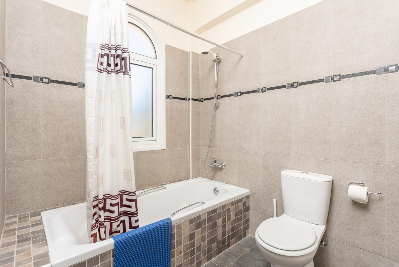 En suite bathroom with bath and shower