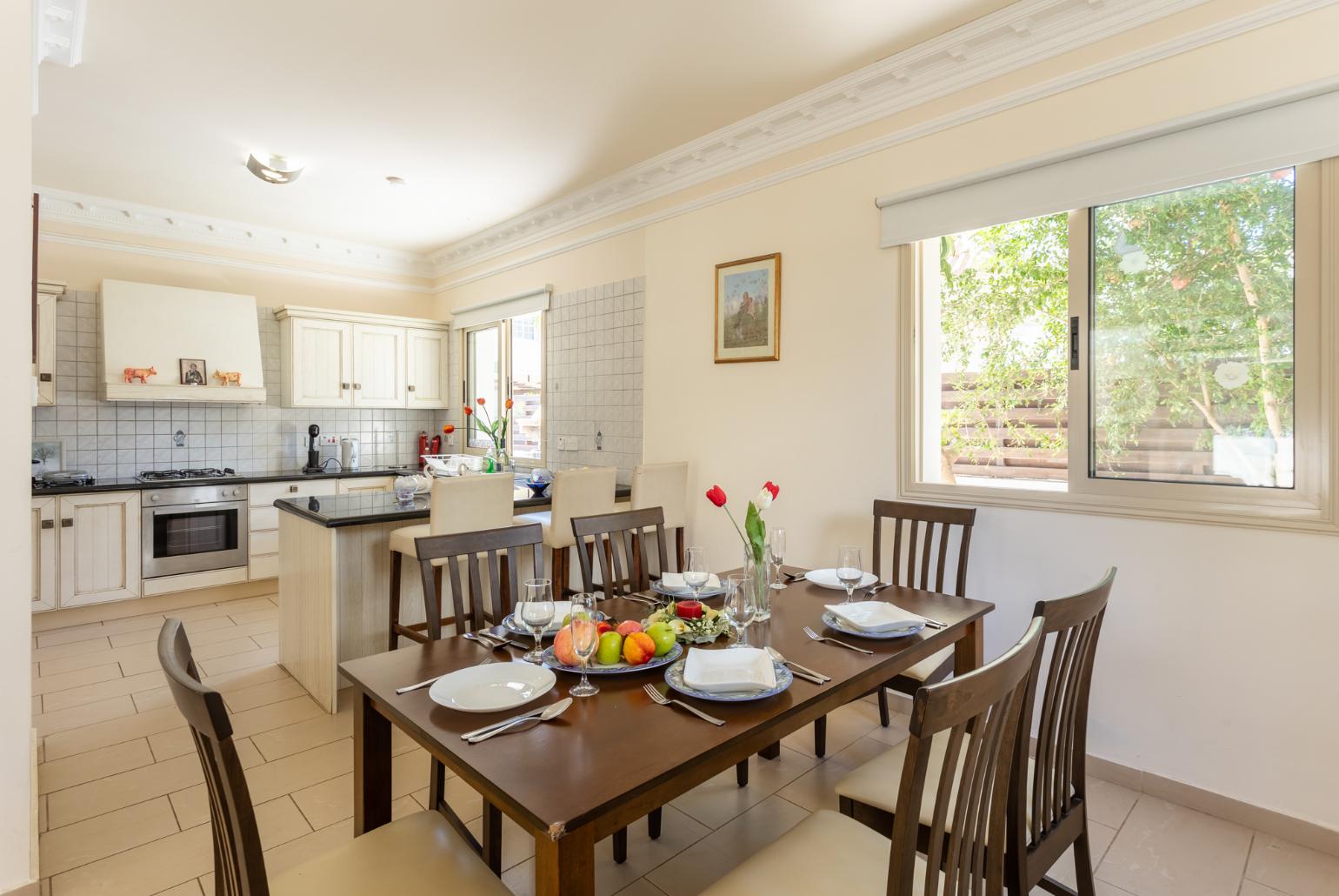 Open-plan living room with sofa, dining area, kitchen, ornamental fireplace, A/C, WiFi internet, and satellite TV