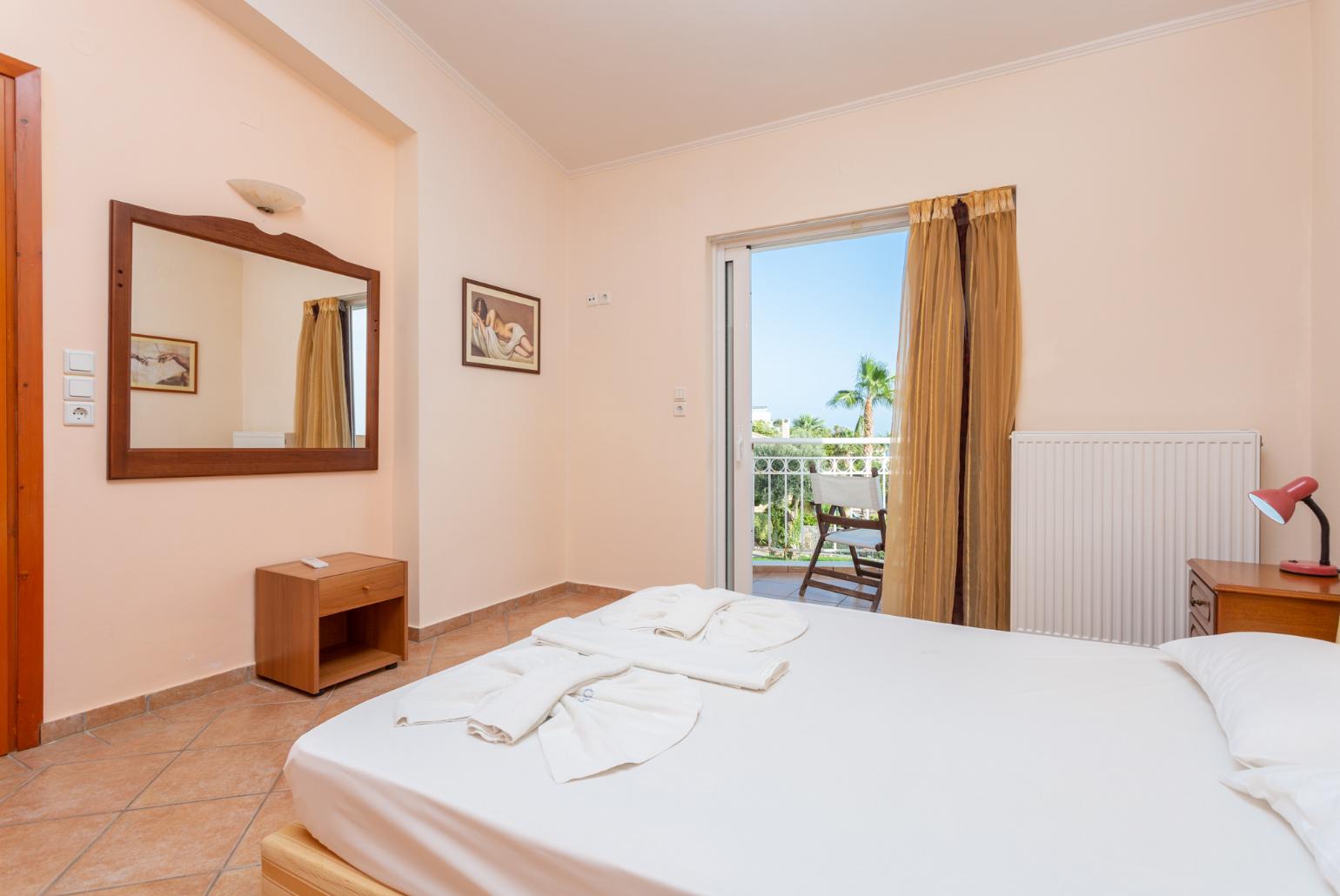 Double bedroom with en suite bathroom, A/C, and balcony access