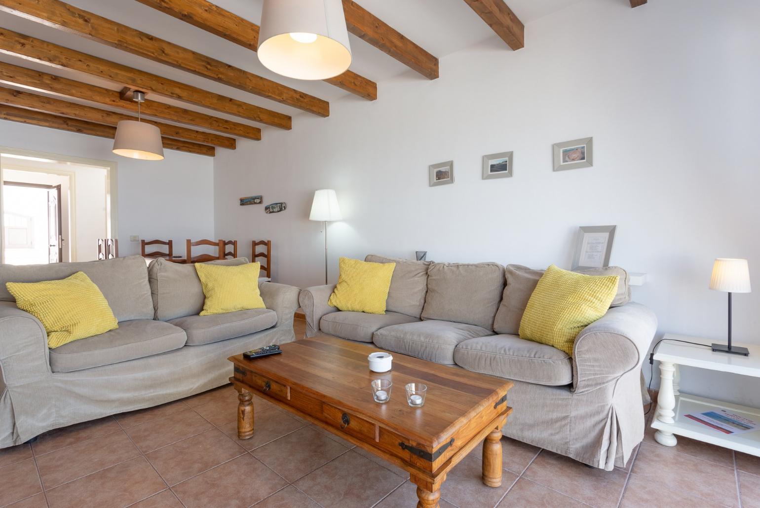 Open-plan living room with dining area, WiFi internet, satellite TV, and terrace access