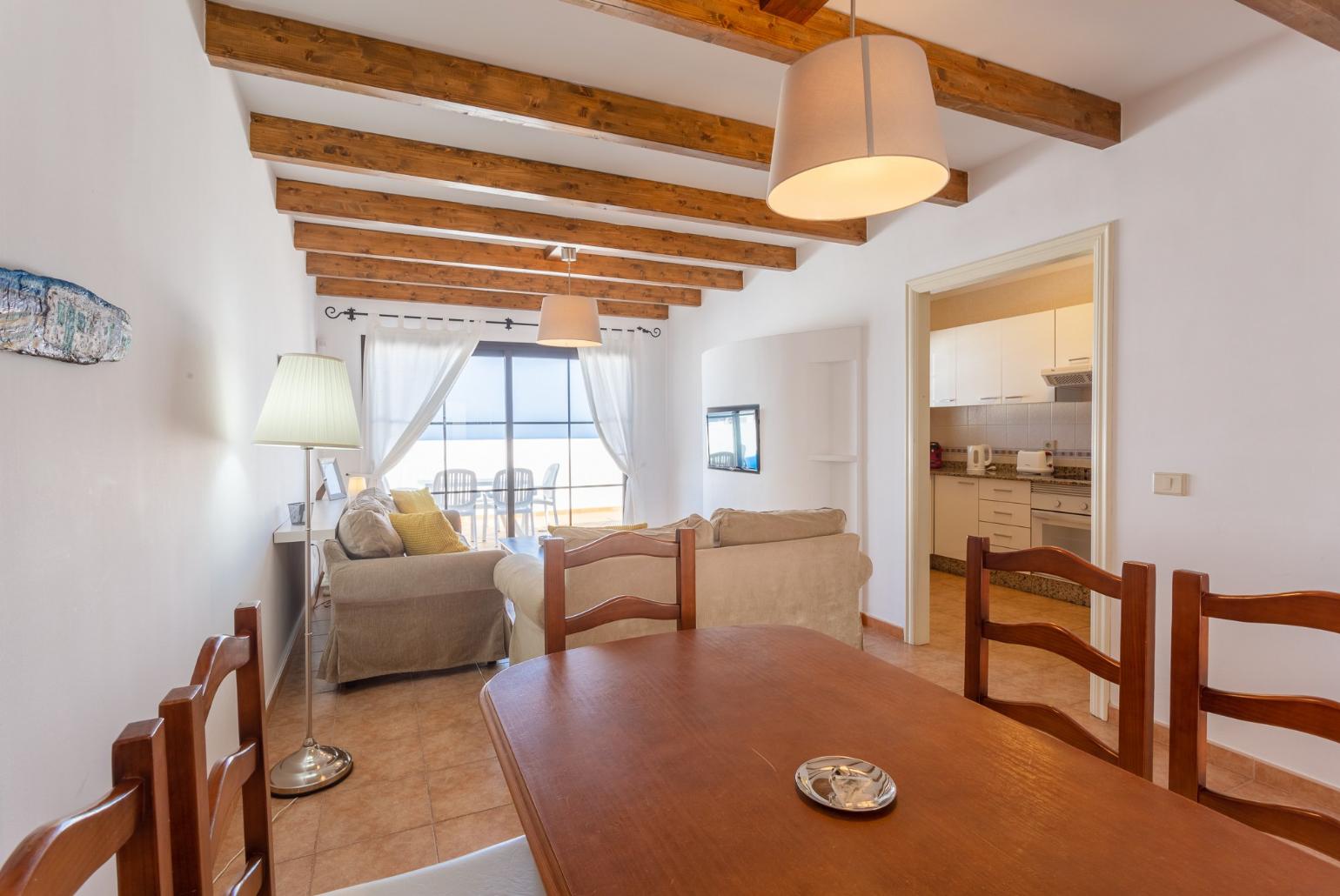 Open-plan living room with dining area, WiFi internet, satellite TV, and terrace access