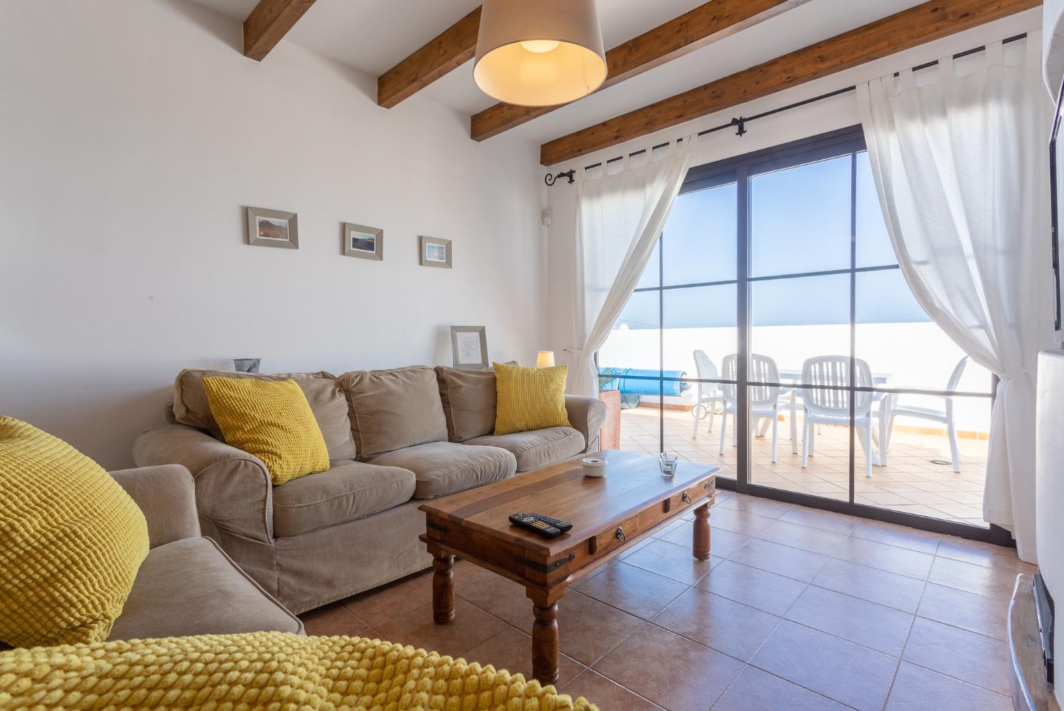 Open-plan living room with dining area, WiFi internet, satellite TV, and terrace access