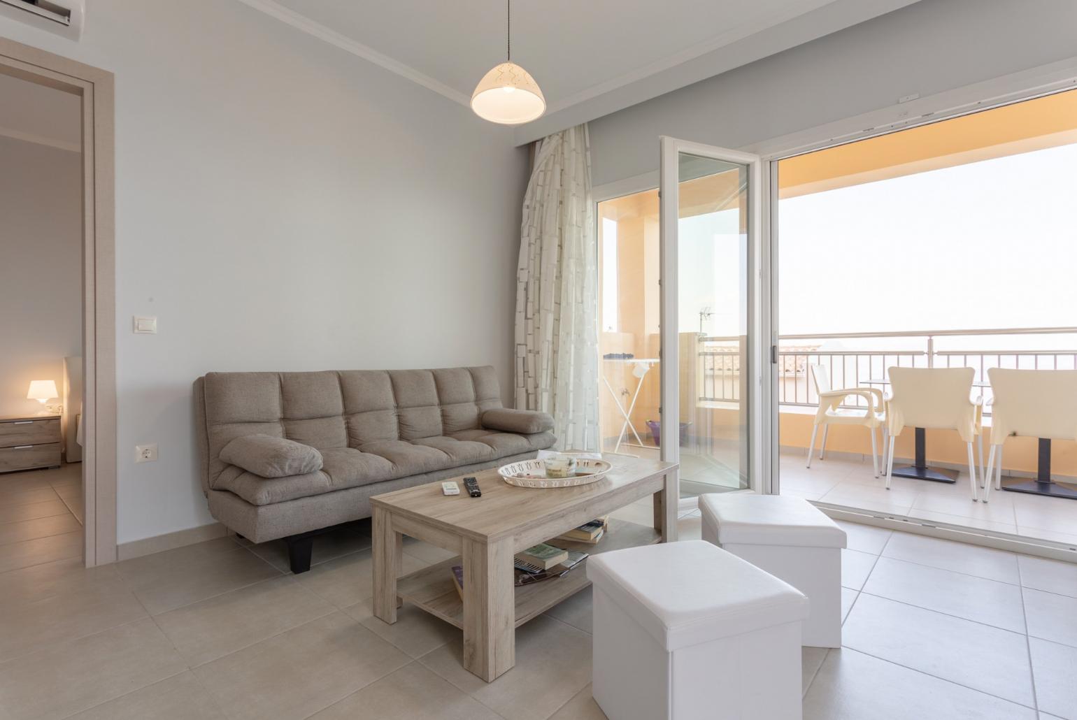 Open-plan living room with dining area, kitchen, A/C, WiFi internet, satellite TV, and terrace and balcony access