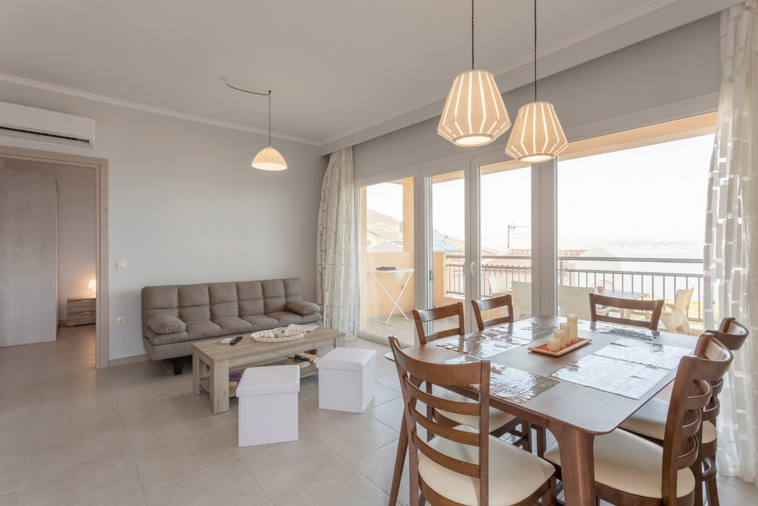 Open-plan living room with dining area, kitchen, A/C, WiFi internet, satellite TV, and terrace and balcony access