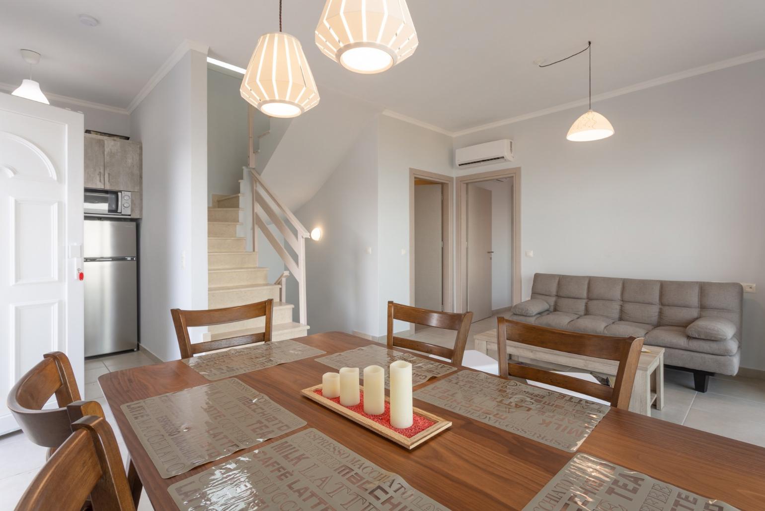 Open-plan living room with dining area, kitchen, A/C, WiFi internet, satellite TV, and terrace and balcony access