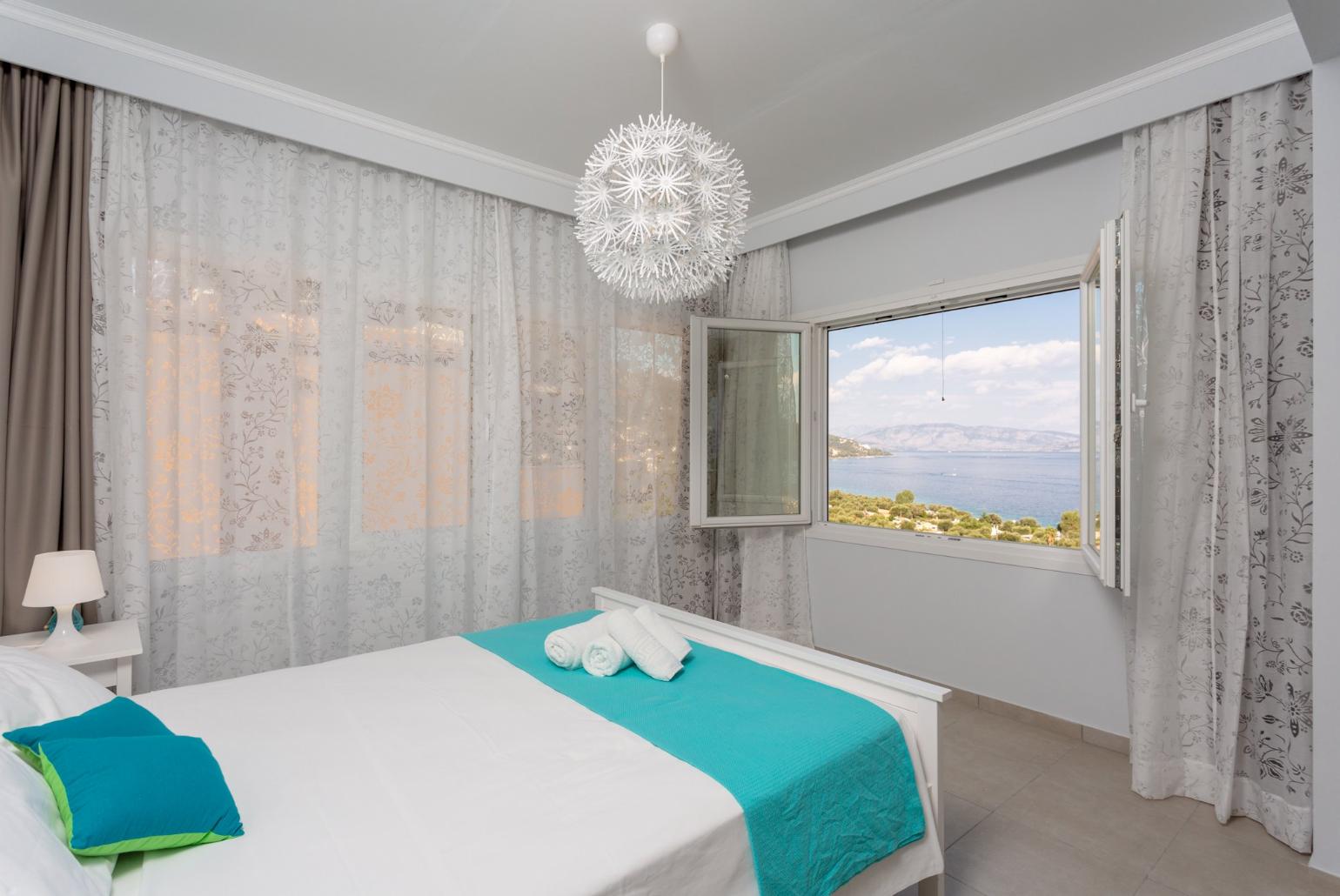 Double bedroom with en suite bathroom, A/C, living area, walk-in wardrobe, and balcony access