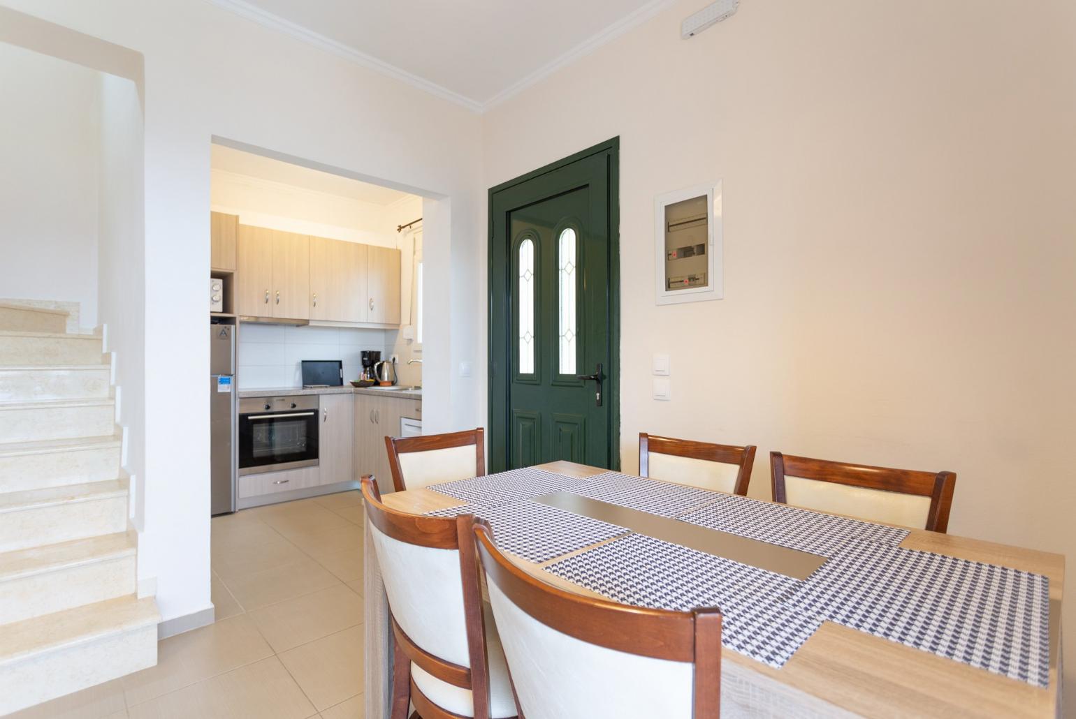 Open-plan living room with dining area, kitchen, A/C, WiFi internet, satellite TV, and balcony access with sea views 