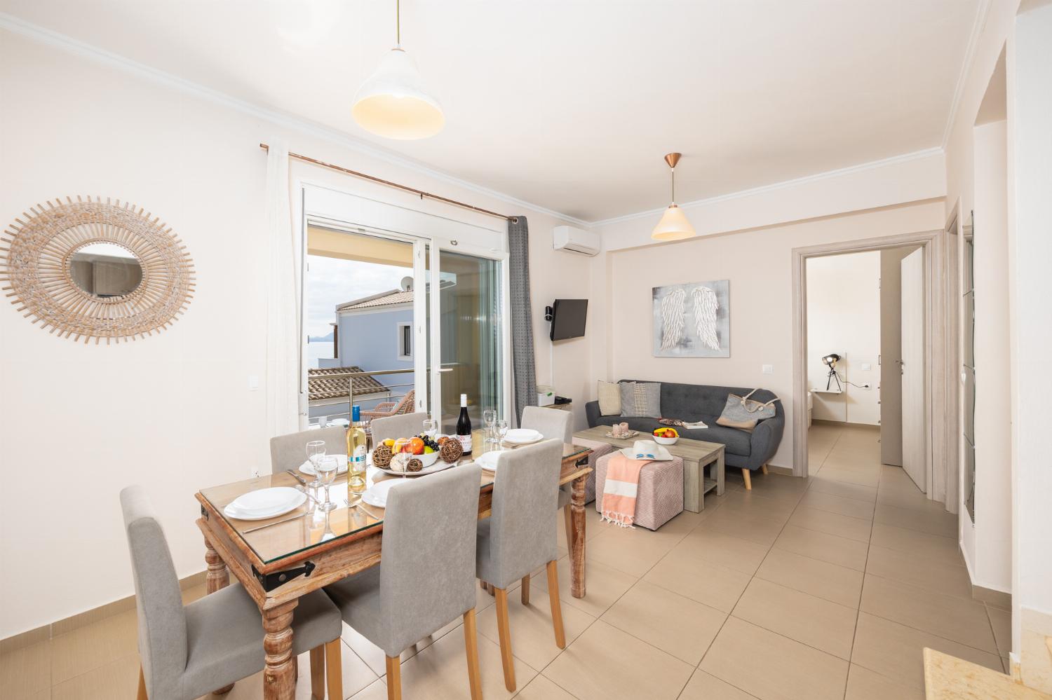 Open-plan living room with sofa, dining area, kitchen, A/C, WiFi internet, satellite TV, and sea views