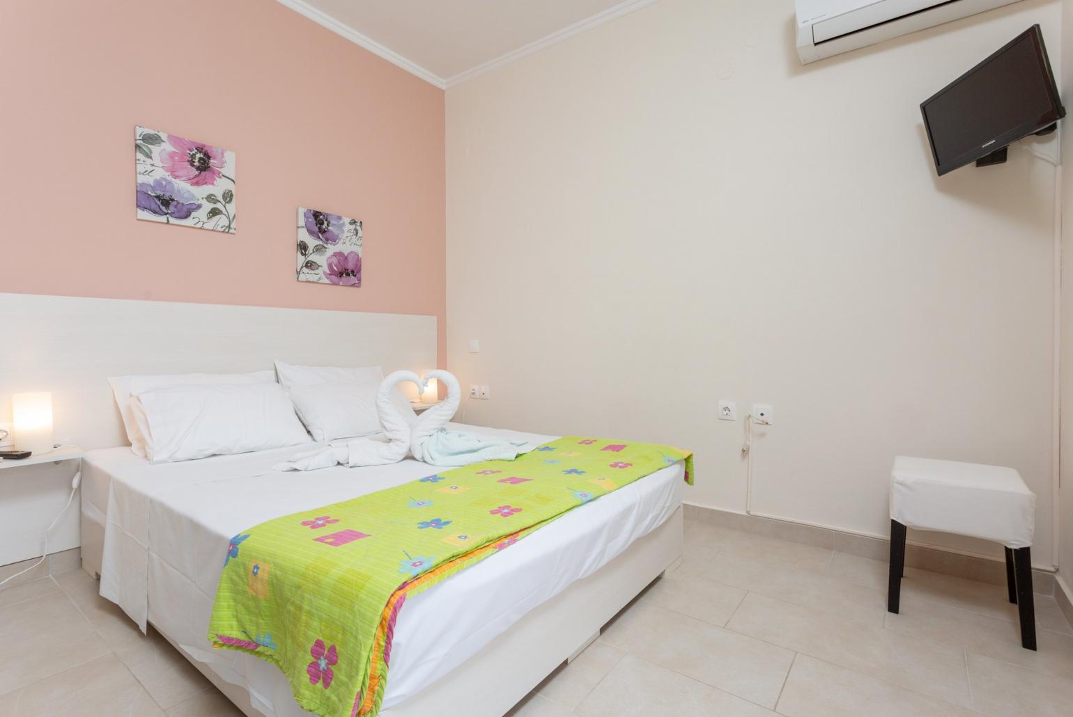 Double bedroom with en suite bathroom, A/C, TV. and balcony access with sea views