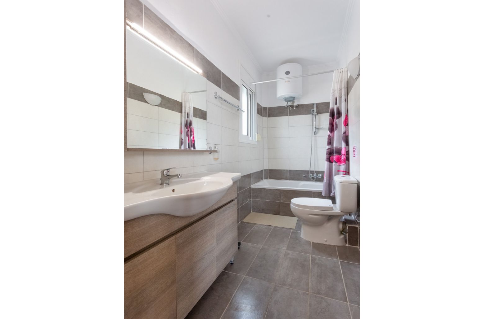 En suite bathroom with bath and overhead shower