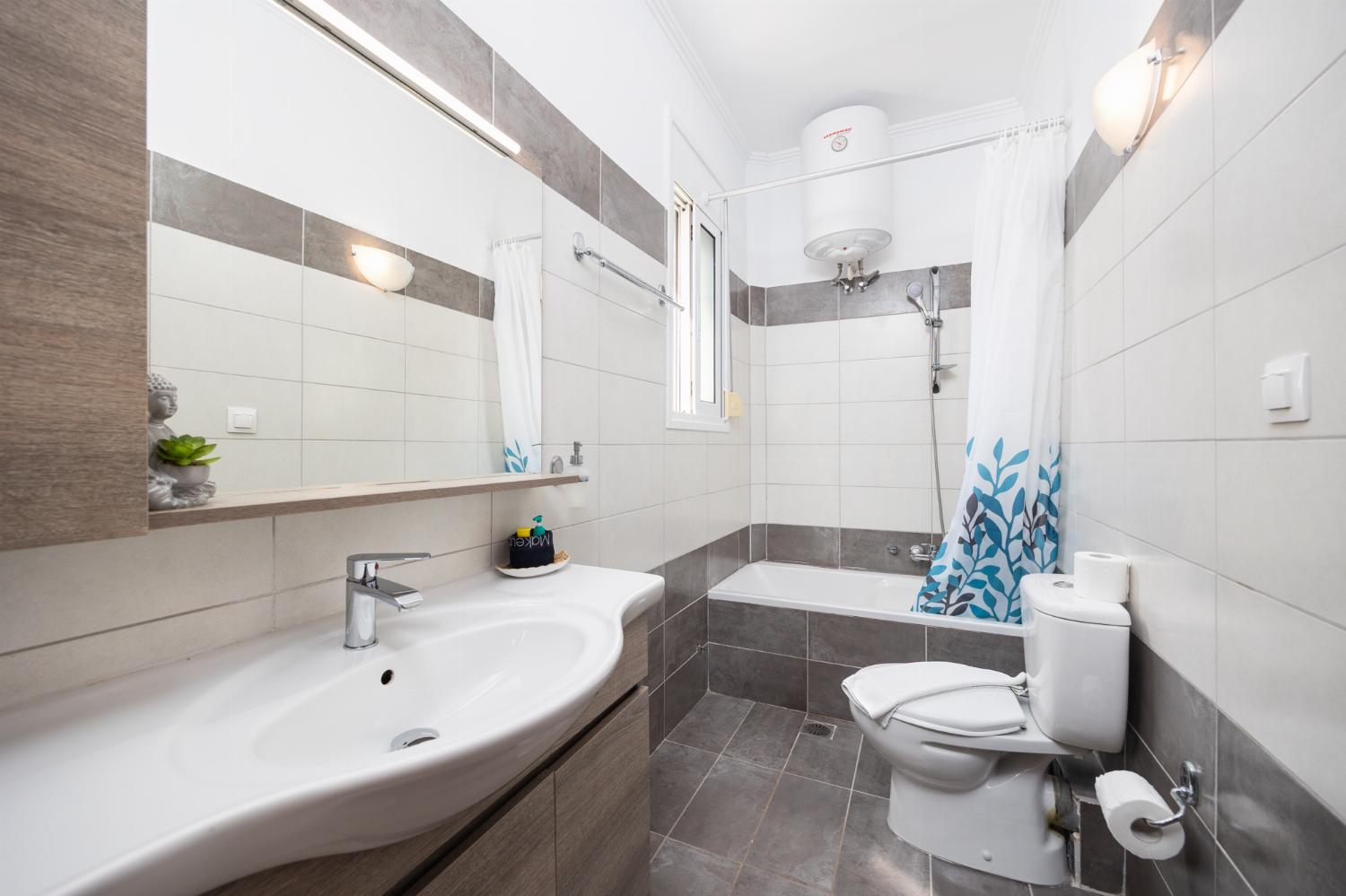 En suite bathroom with bath and shower