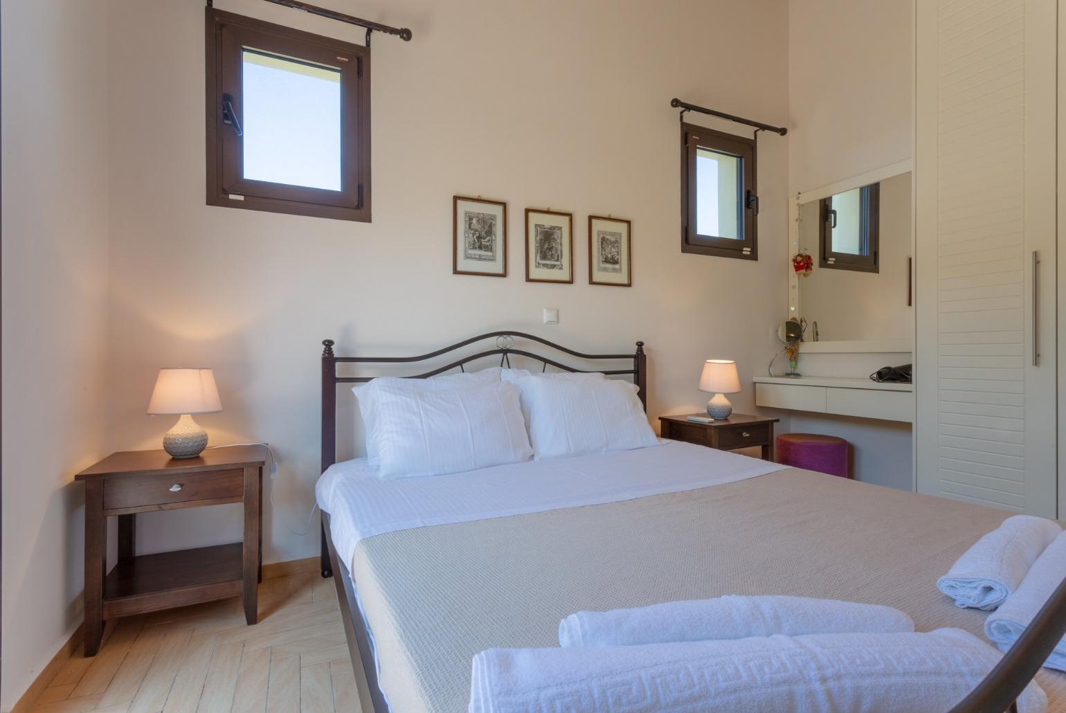 Double bedroom with en suite bathroom, A/C, and balcony access with sea views