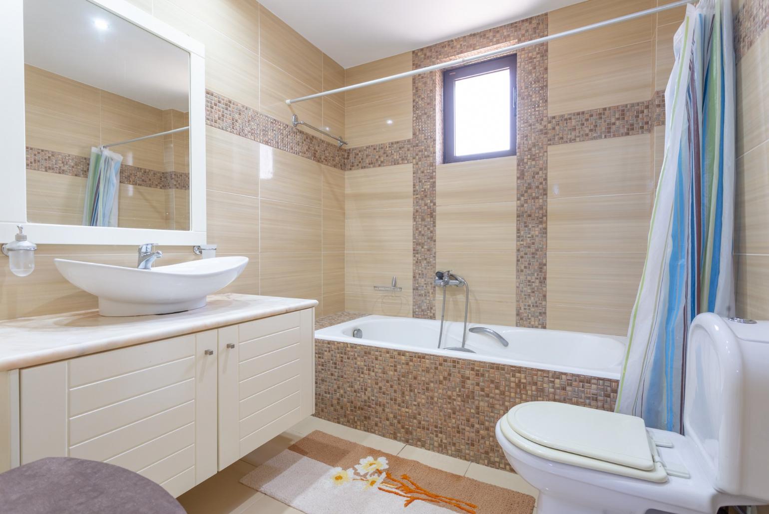 Family bathroom with bath and shower