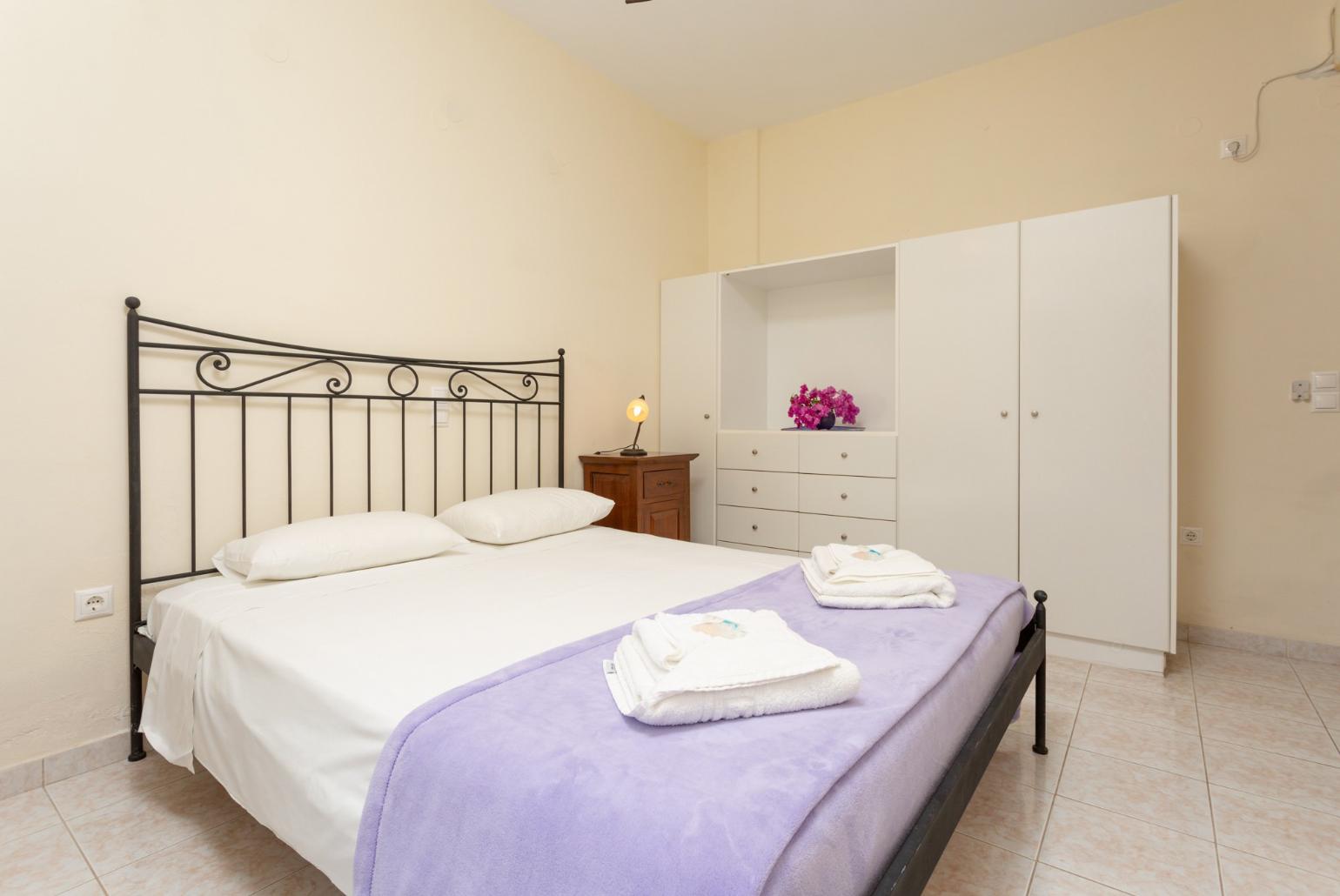 Double bedroom on ground floor with en suite bathroom, A/C, and terrace access