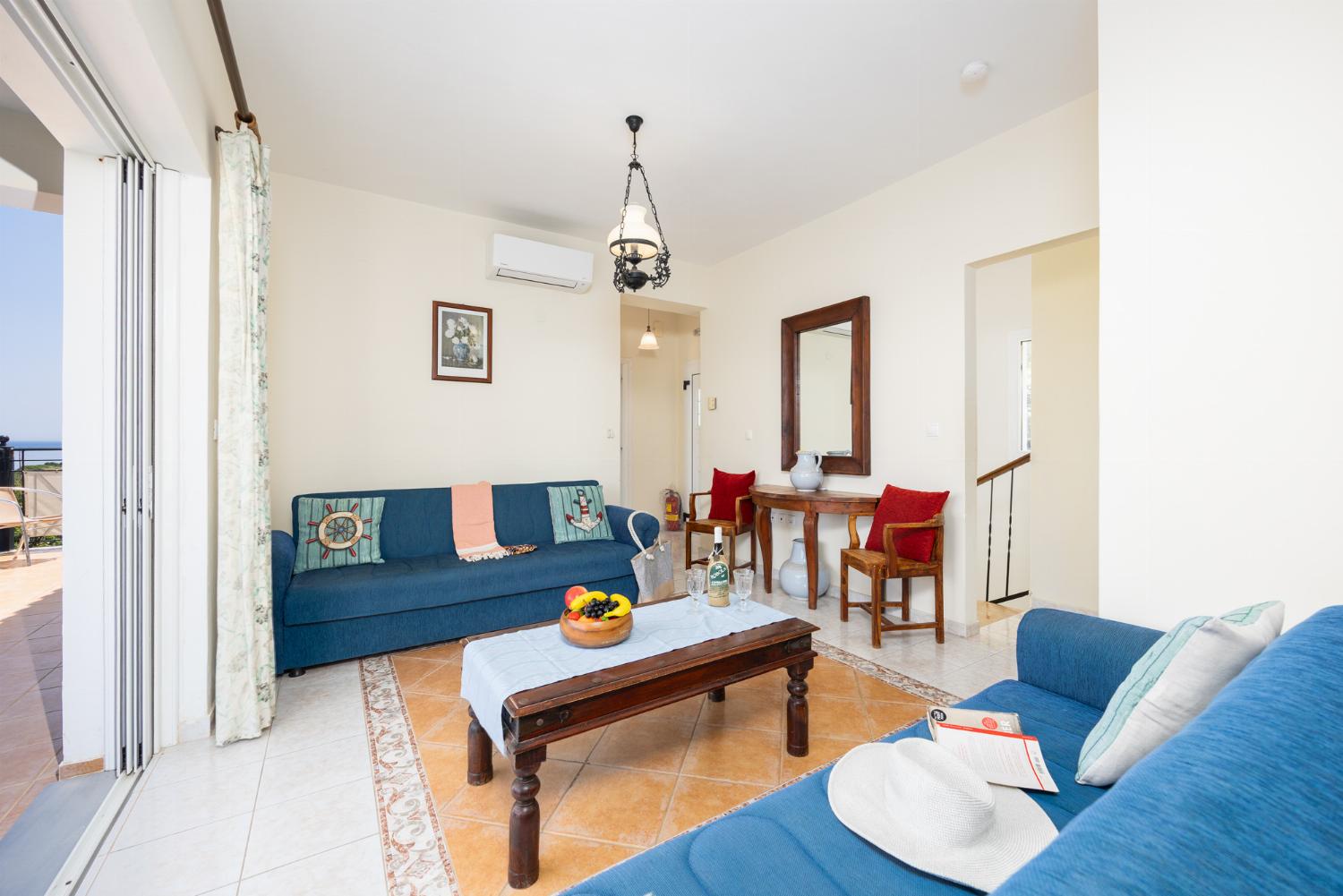 Living room with sofas, A/C, and WiFi internet
