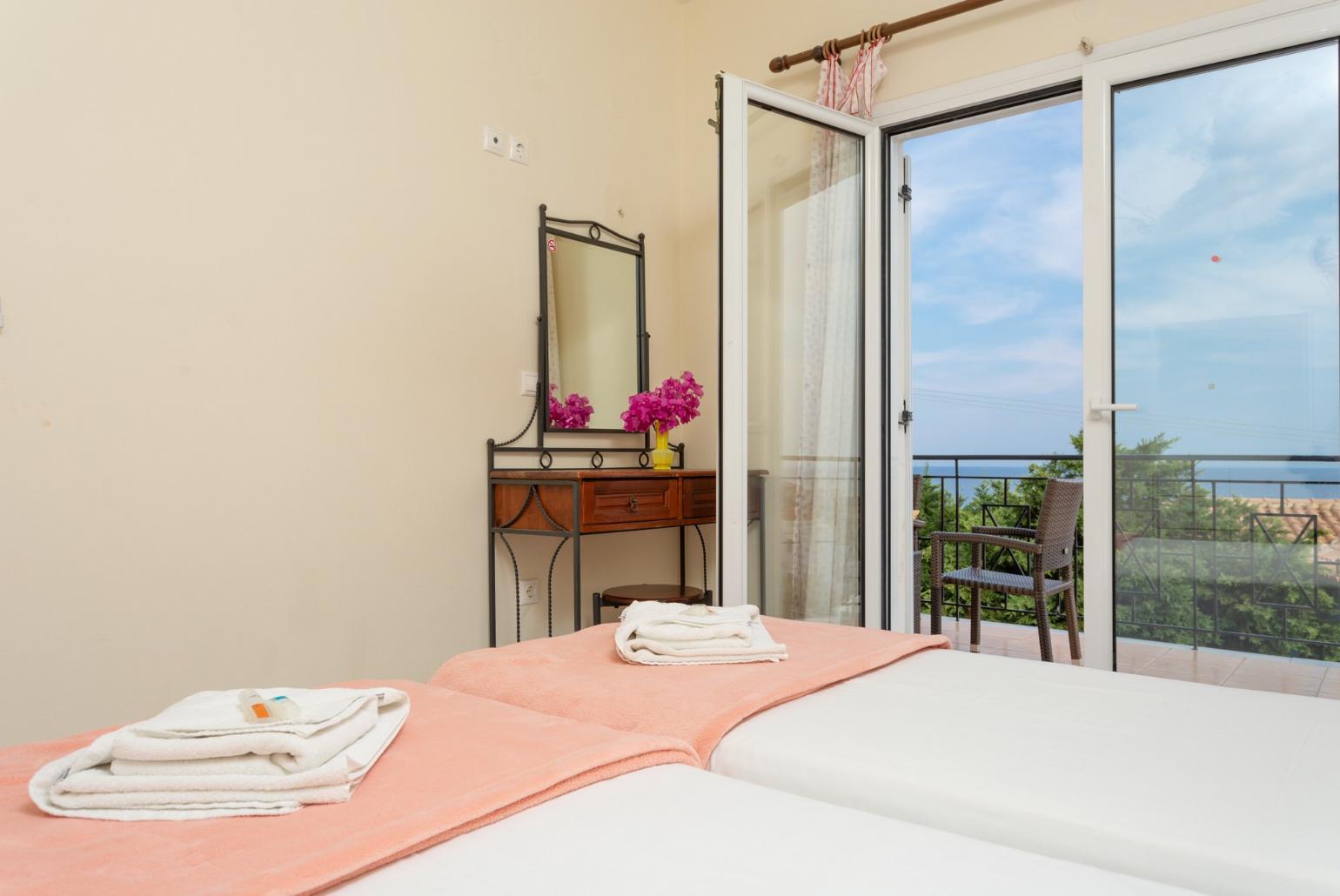 Twin bedroom on first floor with A/C, and balcony access with sea views