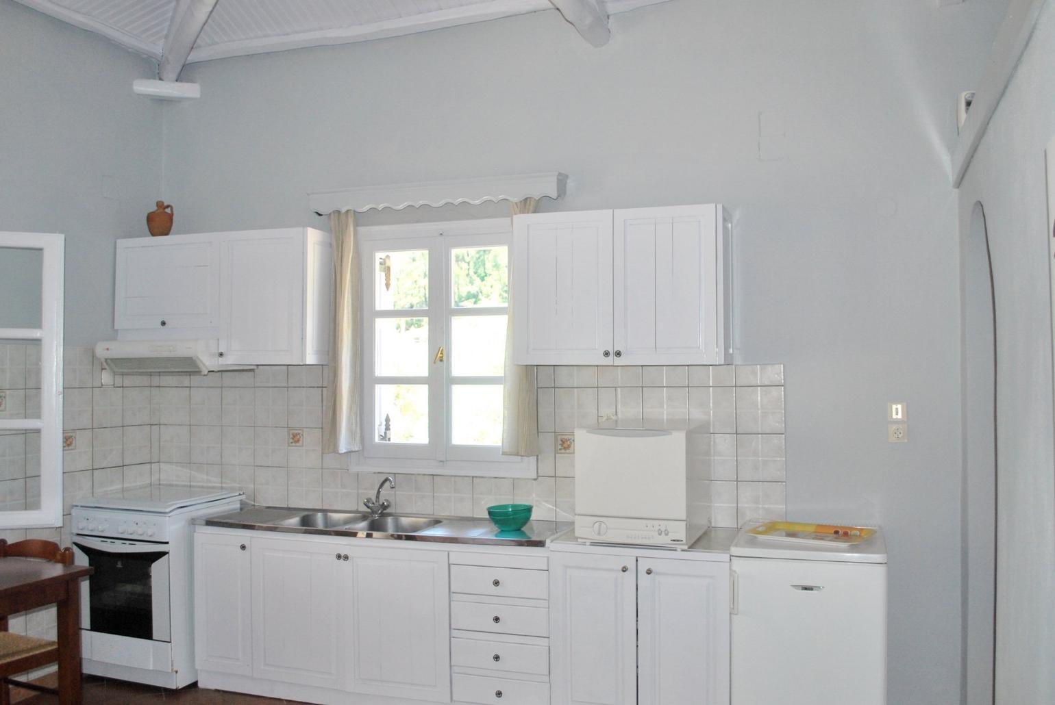 Open-plan living room with sofas, WiFi Internet, Satellite TV, DVD player and dining area.