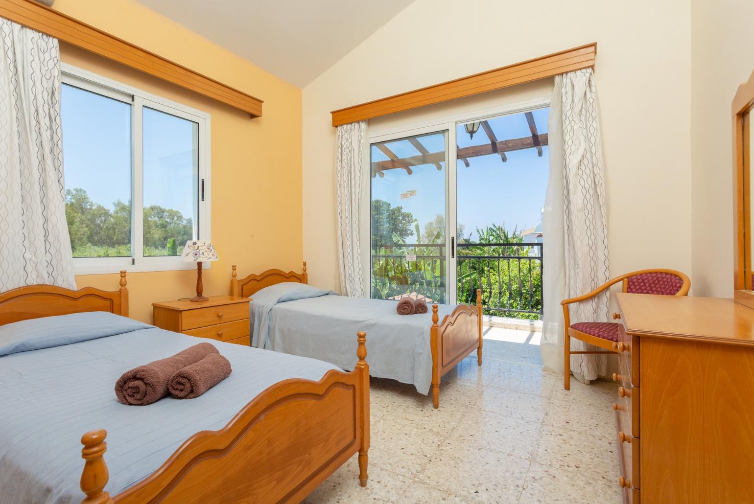 Twin bedroom with en suite bathroom, A/C, and balcony access with sea views